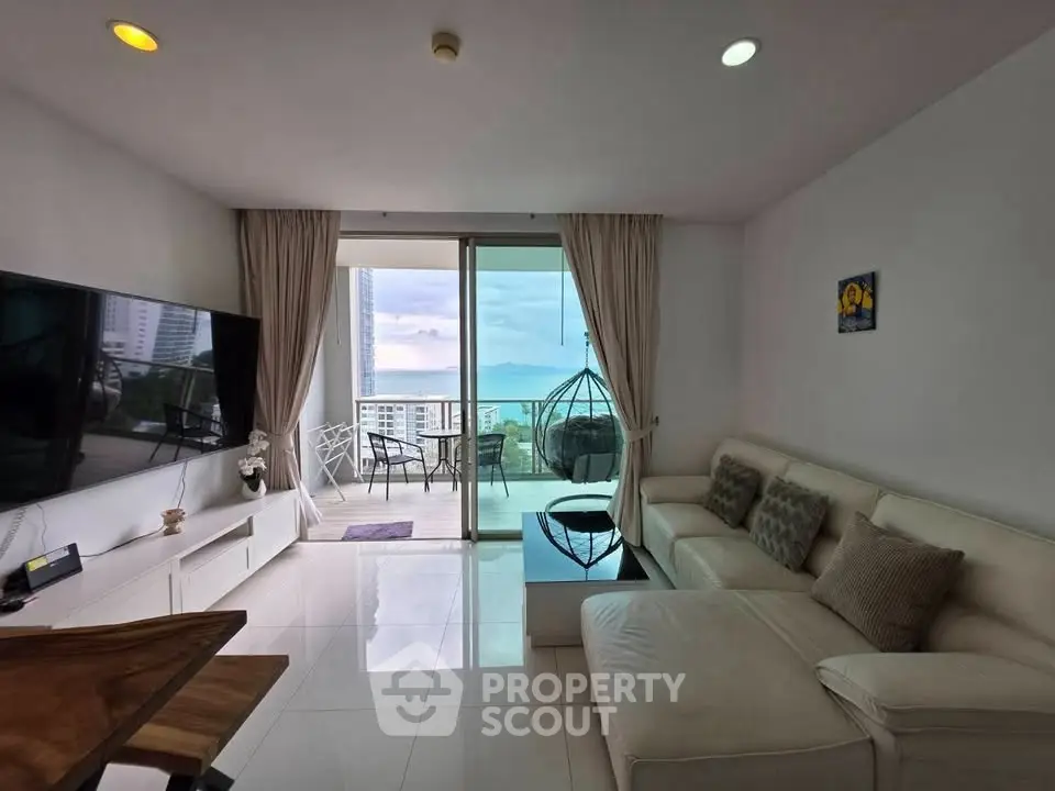 Modern living room with large balcony and stunning ocean view