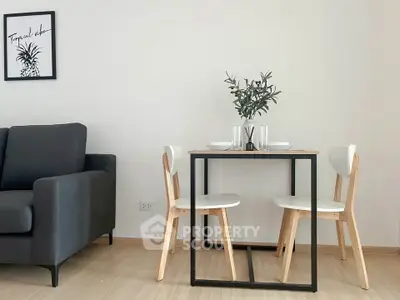 Modern minimalist dining area with sleek table and chairs, adjacent to a cozy sofa, perfect for urban living.
