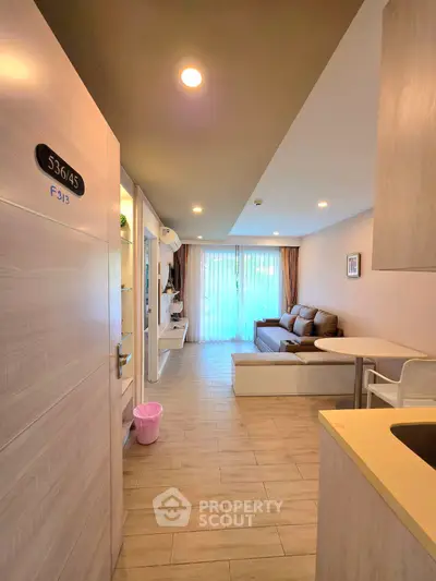 Modern living room with cozy sofa and natural light, perfect for relaxation and entertainment.
