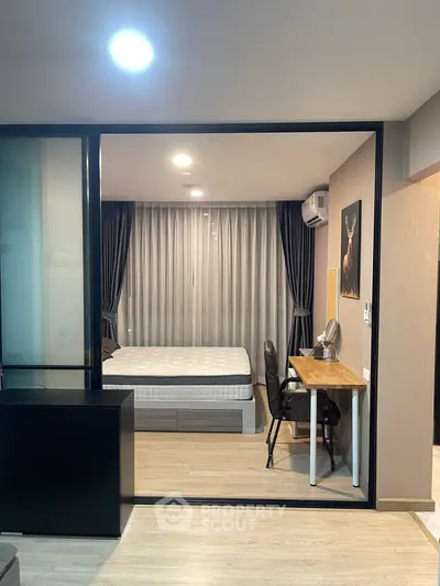 Modern bedroom with study area, featuring a comfortable bed, desk, and stylish decor.