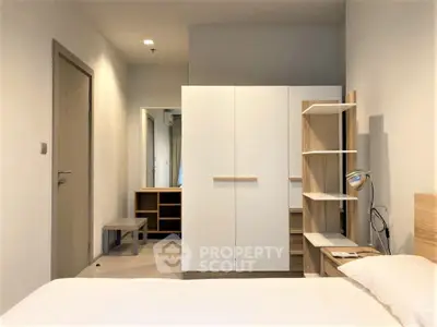 Modern bedroom with sleek white wardrobe and minimalist decor