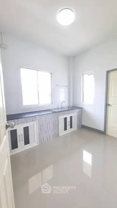 Bright and spacious kitchen with modern design and ample natural light.