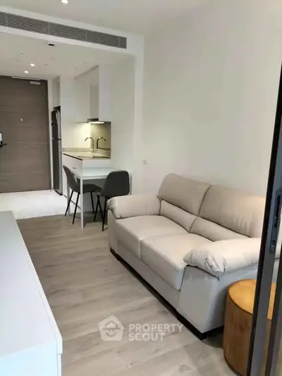 Modern apartment interior with cozy living room and compact kitchen area.