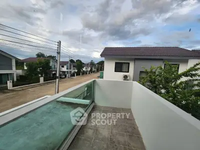 Charming residential neighborhood with modern houses and a cozy balcony view.