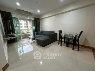 Modern living room with sleek furniture and balcony view in urban apartment.