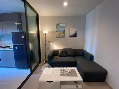 Modern living room with sleek sofa and stylish decor in open layout apartment.
