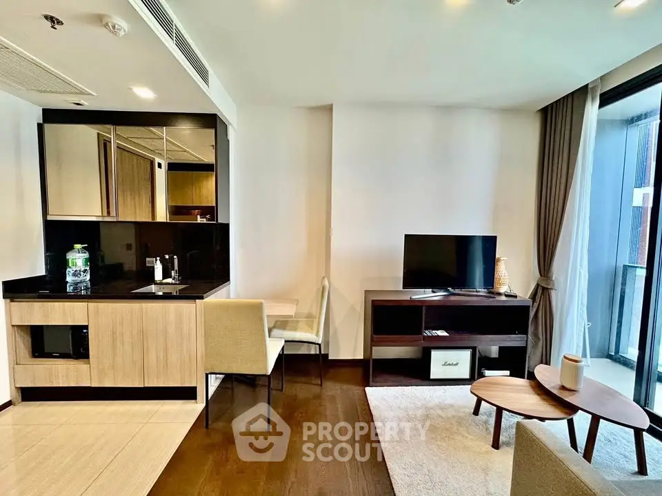 Modern living room with sleek kitchenette and cozy seating area