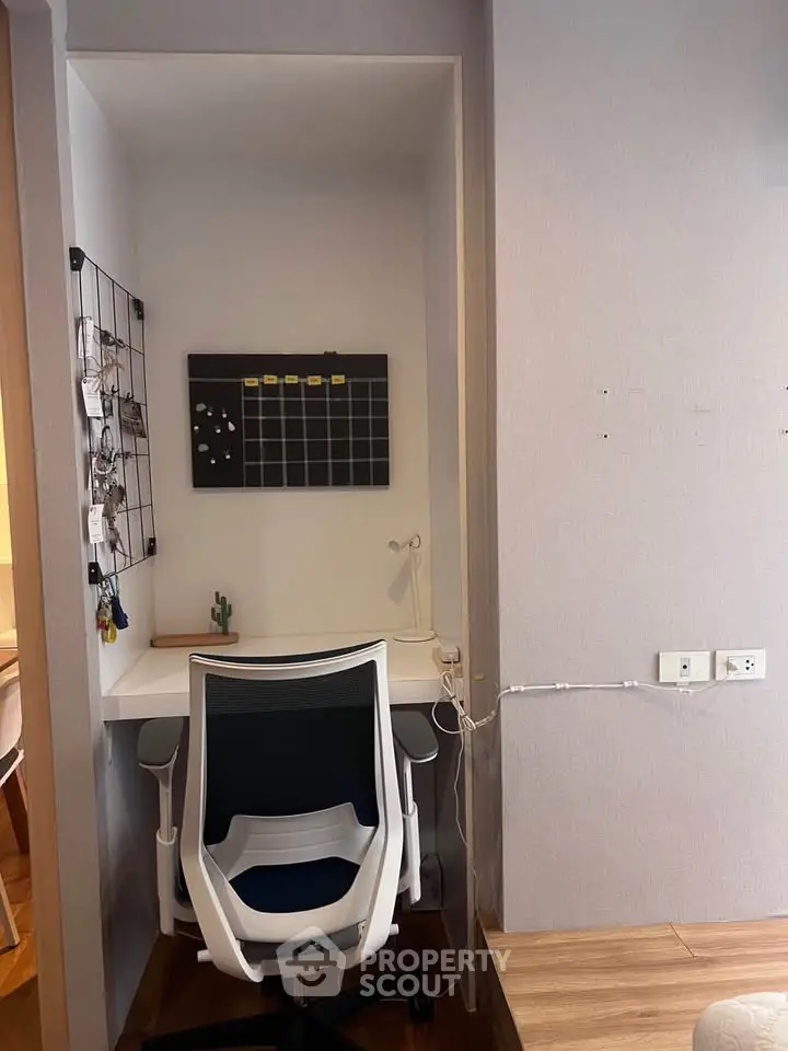 Cozy study nook with modern chair and wall organizer in stylish apartment