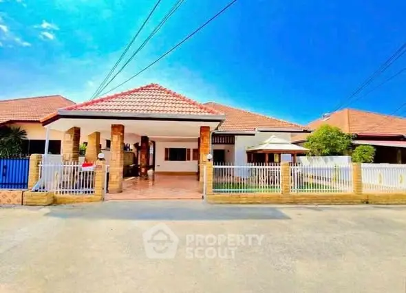 Charming single-story home with tiled roof and spacious front yard in a serene neighborhood.