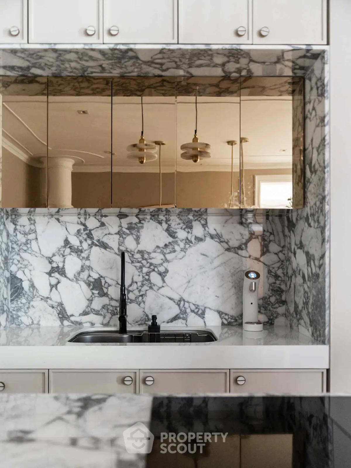 Luxurious kitchen with marble backsplash and modern fixtures