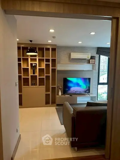Modern living room with built-in shelving and large window view