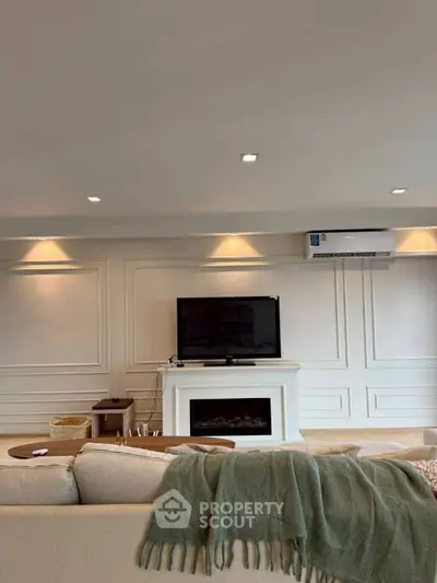 Elegant living room with modern decor and wall-mounted TV