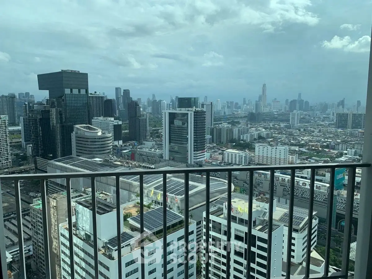 Stunning cityscape view from a high-rise balcony showcasing urban skyline and modern architecture.