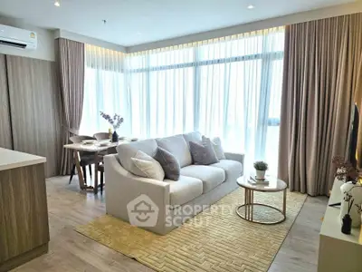 Modern living room with elegant decor and large windows in a stylish apartment.