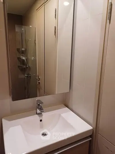 Modern bathroom with sleek sink and mirrored cabinet