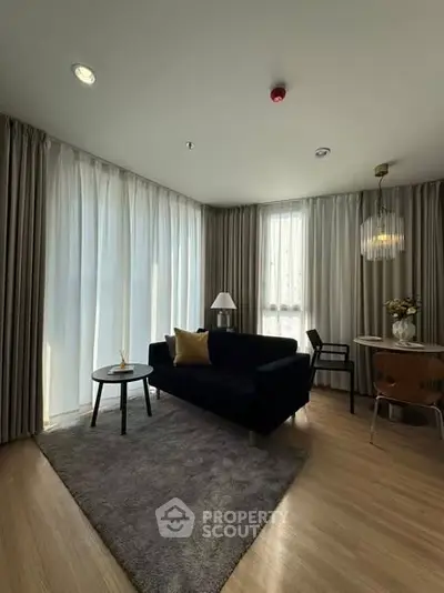 Modern living room with elegant decor and large windows in a stylish apartment.