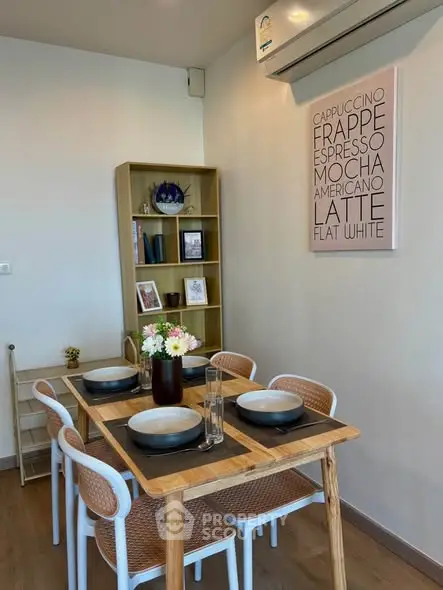 Charming dining area with wooden table, modern chairs, and stylish decor in a cozy apartment setting.