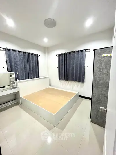 Modern bedroom with minimalist design and ample natural light