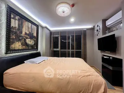 Luxurious bedroom with modern decor and ambient lighting, featuring a large bed and wall-mounted TV.