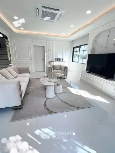 Luxurious modern living room with elegant decor and large TV