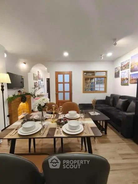 Stylish living room with elegant dining setup and cozy seating area, perfect for entertaining guests.