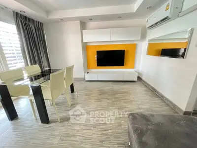 Modern living room with sleek furniture and vibrant accent wall
