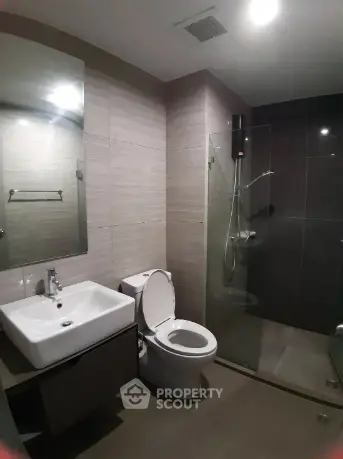Modern bathroom with sleek fixtures and glass shower enclosure