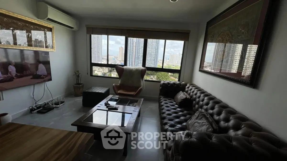 Stylish living room with panoramic city view, luxurious leather sofa, and modern decor in high-rise apartment.