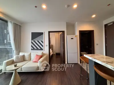 Modern living room with stylish decor and open kitchen layout in a contemporary apartment.