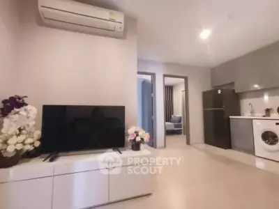 Modern living room with sleek furniture and integrated kitchen appliances