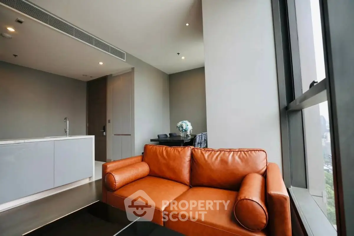 Modern living room with sleek leather sofa and large window view