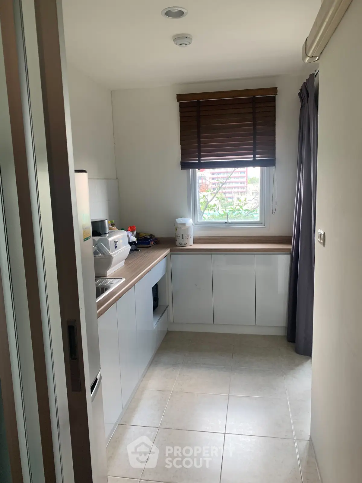 Modern kitchen with sleek cabinetry and natural light, perfect for culinary enthusiasts.