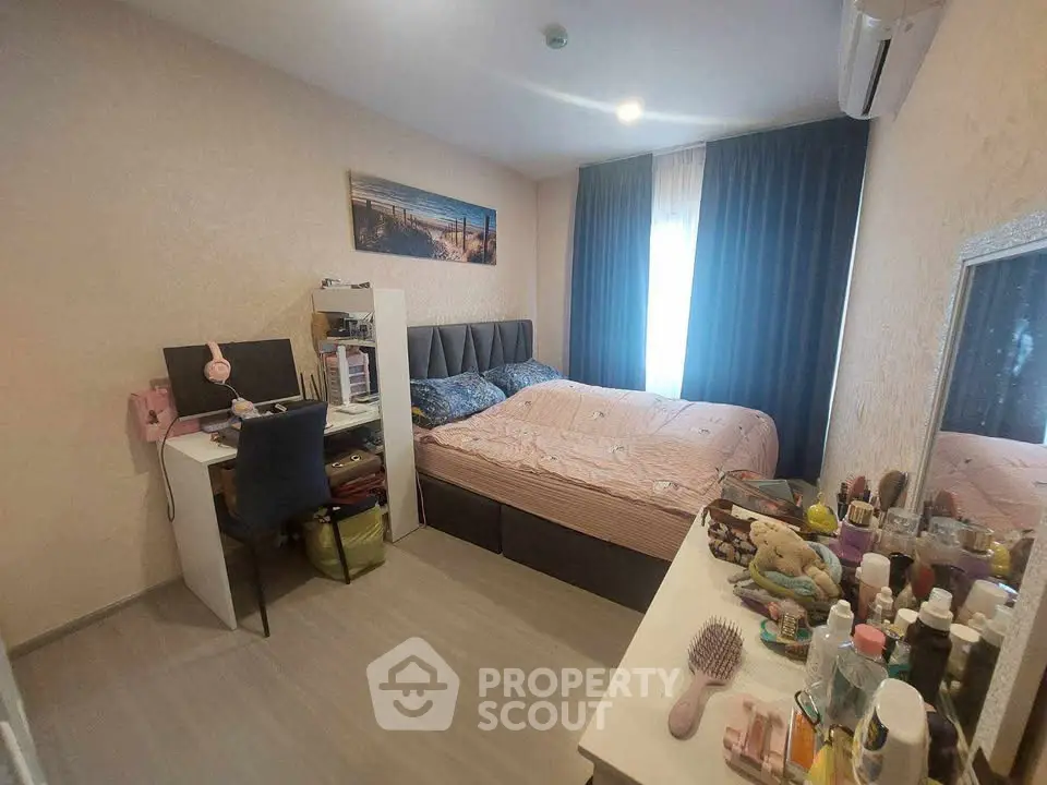 Cozy bedroom with modern decor, featuring a comfortable bed, desk, and ample natural light.