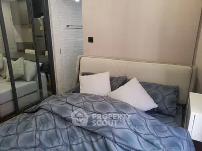 Cozy bedroom with modern decor and comfortable bedding in a stylish apartment.