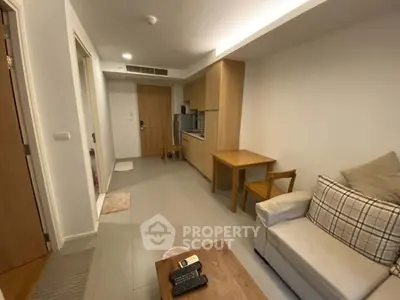 Cozy living room with modern furniture and compact kitchen area
