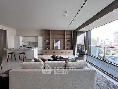 Luxurious open-plan living room with modern kitchen and stunning city view balcony.