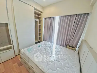 Cozy bedroom with built-in wardrobe and natural light