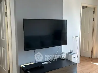Modern living room with wall-mounted TV and sleek furniture
