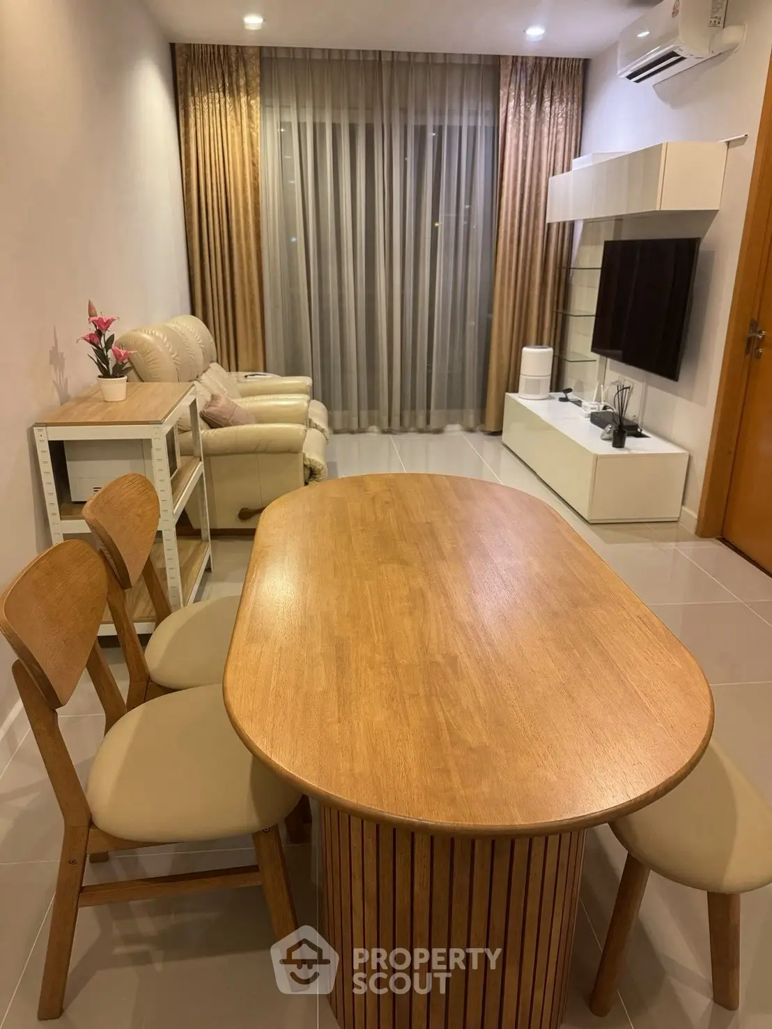 Modern living room with cozy seating and stylish wooden dining table