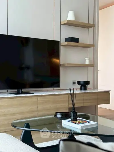 Modern living room with sleek TV setup and stylish shelving