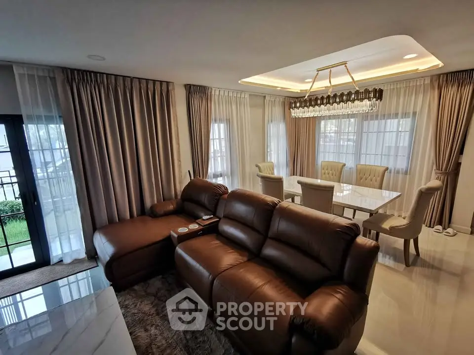 Luxurious living room with elegant dining area and plush leather sofa, perfect for modern family gatherings.