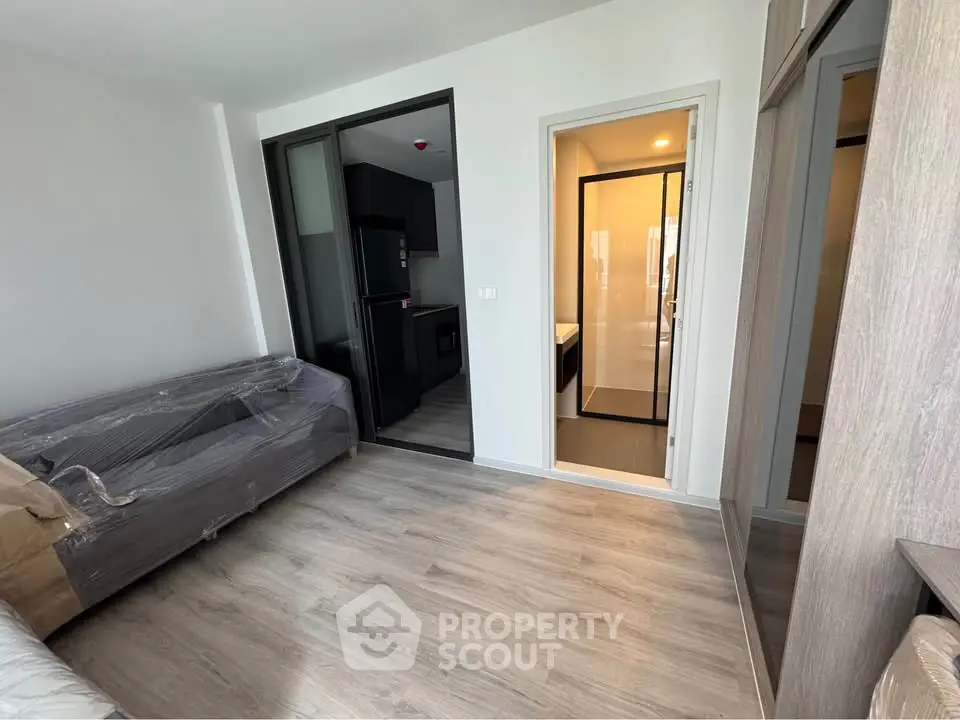 Modern apartment interior with sleek design and open layout, featuring a cozy living area and stylish kitchen.