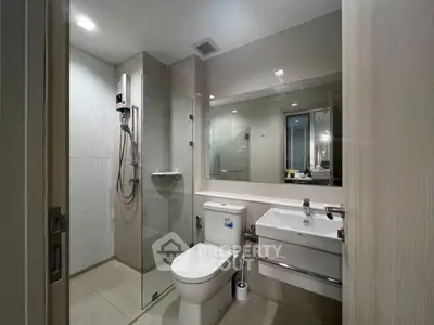 Modern bathroom with glass shower and sleek fixtures