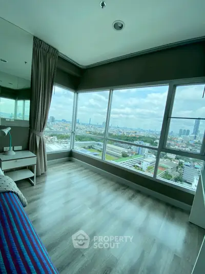 Spacious bedroom with stunning city view and large windows