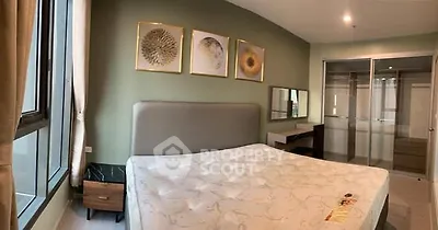 Spacious bedroom with modern decor and large windows for natural light.