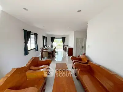 Spacious living room with elegant wooden furniture and large windows