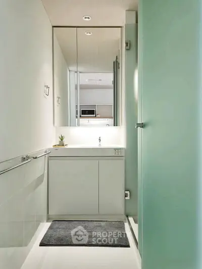 Modern minimalist bathroom with sleek design and ample lighting