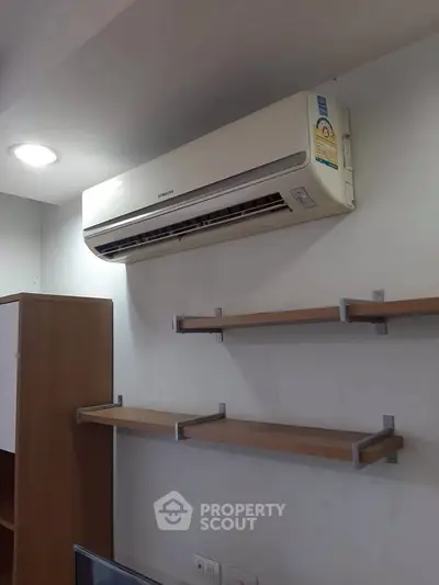 Modern interior with air conditioning and stylish shelving in a cozy living space.