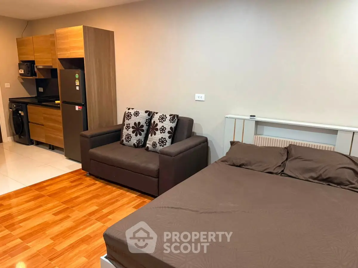 Modern studio apartment with cozy living area and compact kitchen