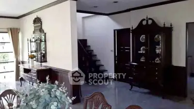 Elegant living room with classic wooden furniture and staircase